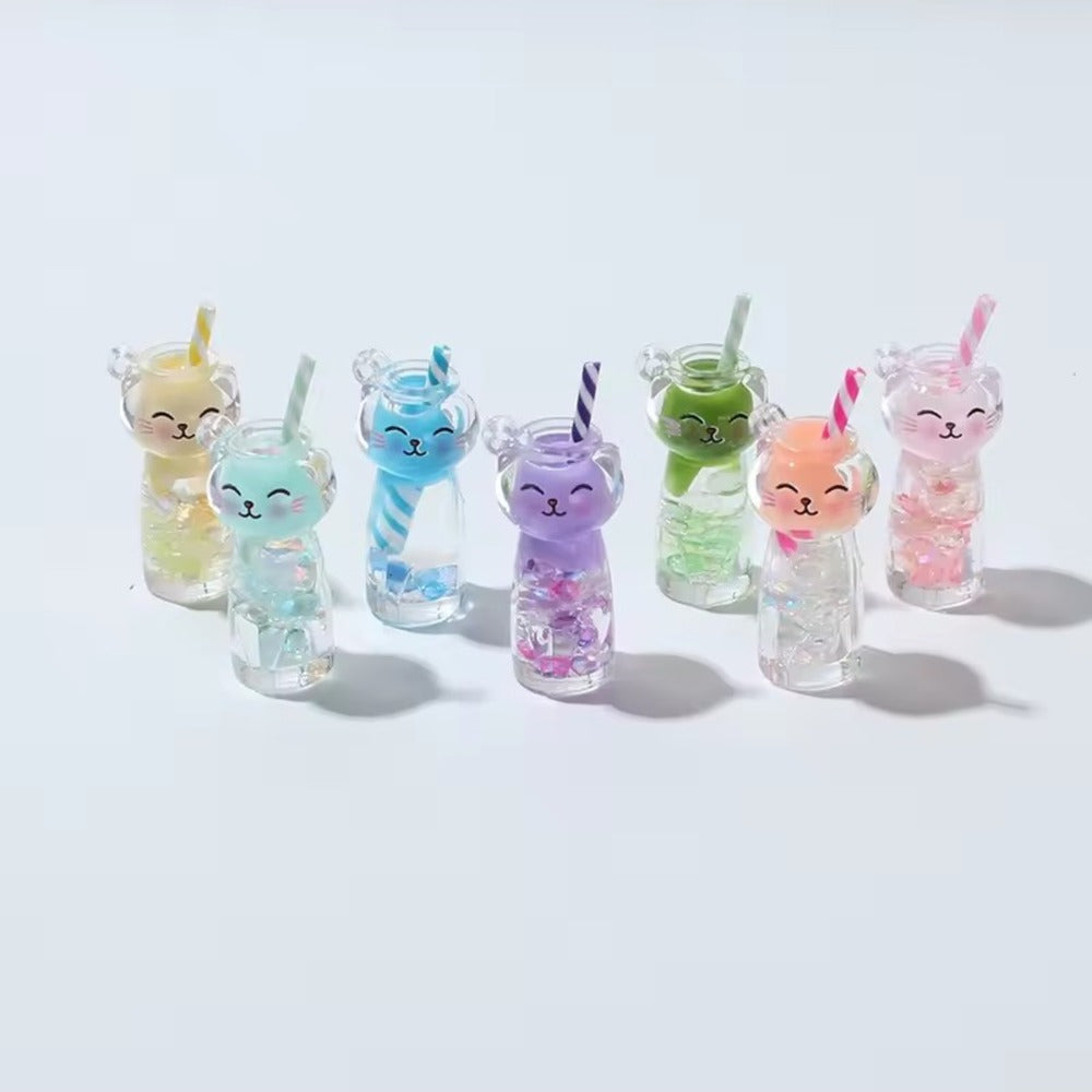 Assortiment de sept porte-clés chat boba alignés : jaune, menthe, bleu rayé, violet, vert, orange et rose
